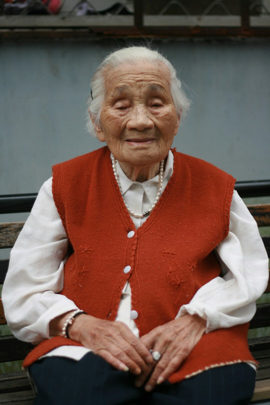 Elderly Danish woman smiling warmly while telling a story