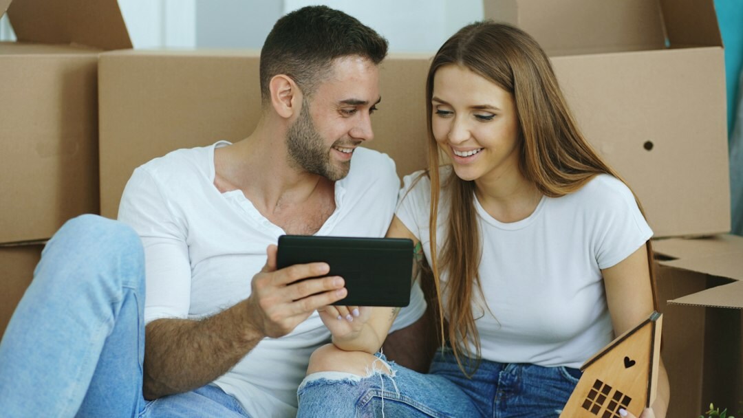 Danish couple reading a tablet together at home